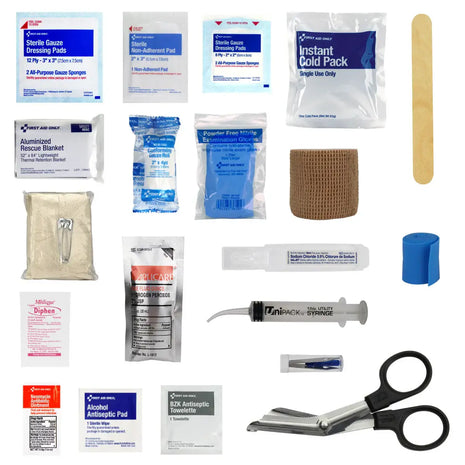 Collection of first aid supplies including bandages, gauze, and scissors on a white background
