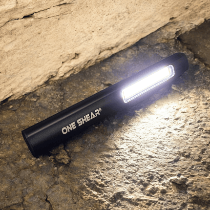 ONE SHEAR® XPE+COB USB-C rechargeable magnetic penlight illuminating a surface.