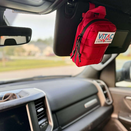 ViTAC EDC Trauma Kit hanging in a vehicle, showcasing its compact design for everyday preparedness.
