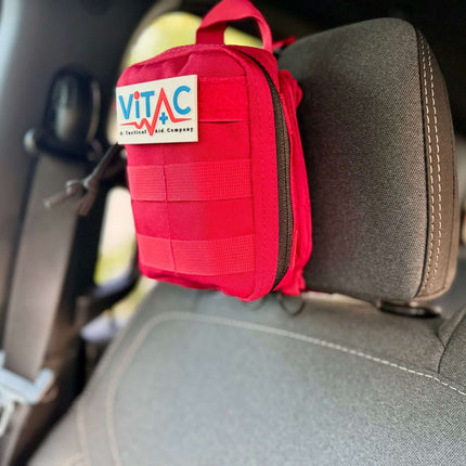ViTAC EDC Trauma Kit attached to a car seat, showcasing its compact and rugged design for everyday carry.