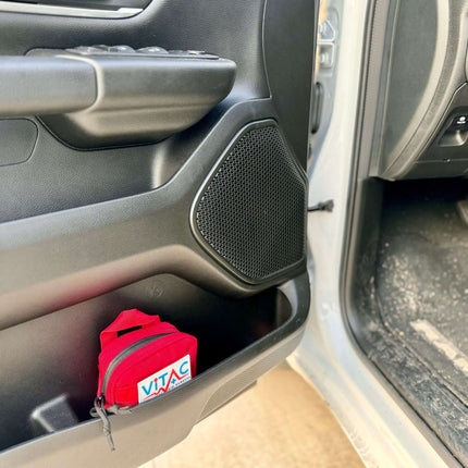 ViTAC EDC Trauma Kit stored in a car door pocket, showcasing compact design for everyday carry and readiness.