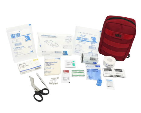 Compact IFAK contents including bandages, scissors, and medical supplies for first aid.