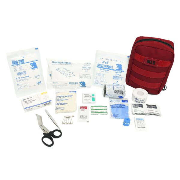 Compact IFAK contents including bandages, scissors, and medical supplies for first aid.