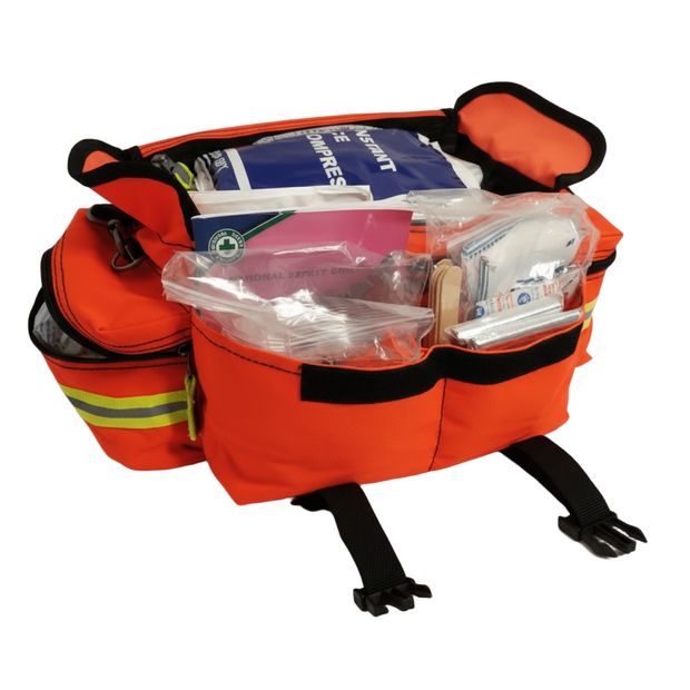 Orange emergency medical bag with supplies on a black background