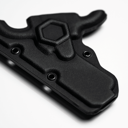 BLACK MINI EMT SHEARS Kydex holder displayed on a smooth surface, highlighting its sleek design and functionality.