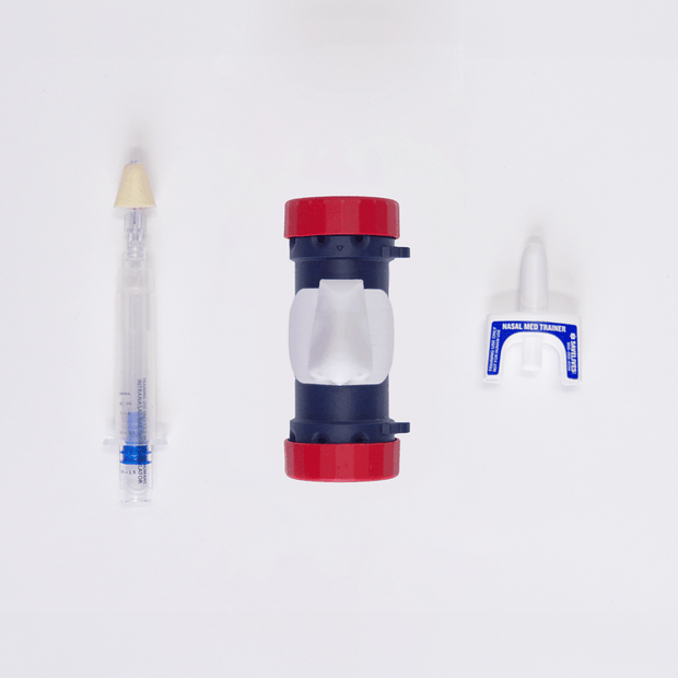 MITS Composite Trainer Kit components including a syringe and nasal med trainer for practicing medical procedures.