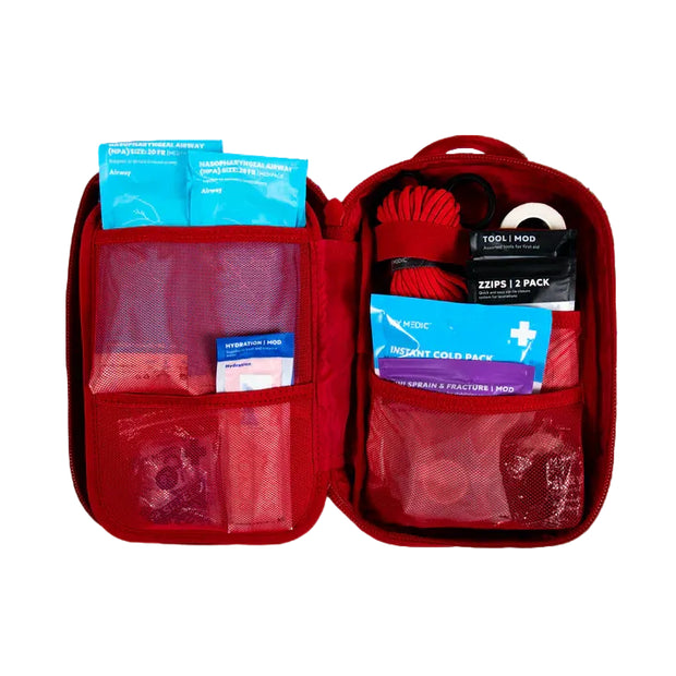 MyFAK First Aid Kit opened showing various medical supplies and organized compartments in a red case.
