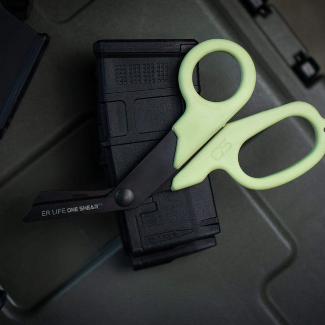 PRO Extreme Rescue Edition trauma shears for EMTs placed on an ammunition magazine, showcasing their cutting efficiency.