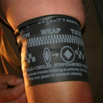 Close-up of SWAT-T multipurpose latex-free tourniquet on arm, featuring stretch, wrap, and tuck instructions for trauma care.